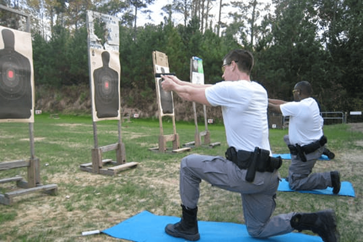 Two officers practicing shooting at targets.