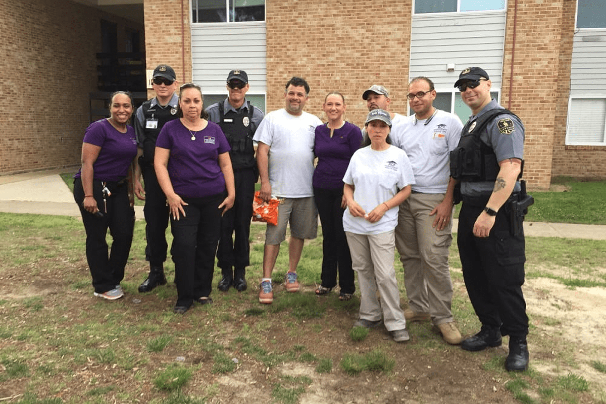 Group of people standing outside a building.