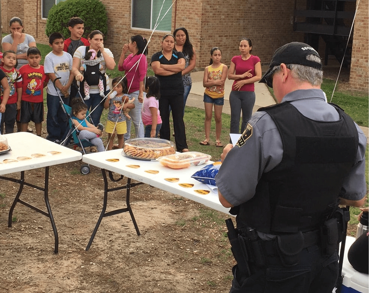 Officer interacting with community at outdoor event.